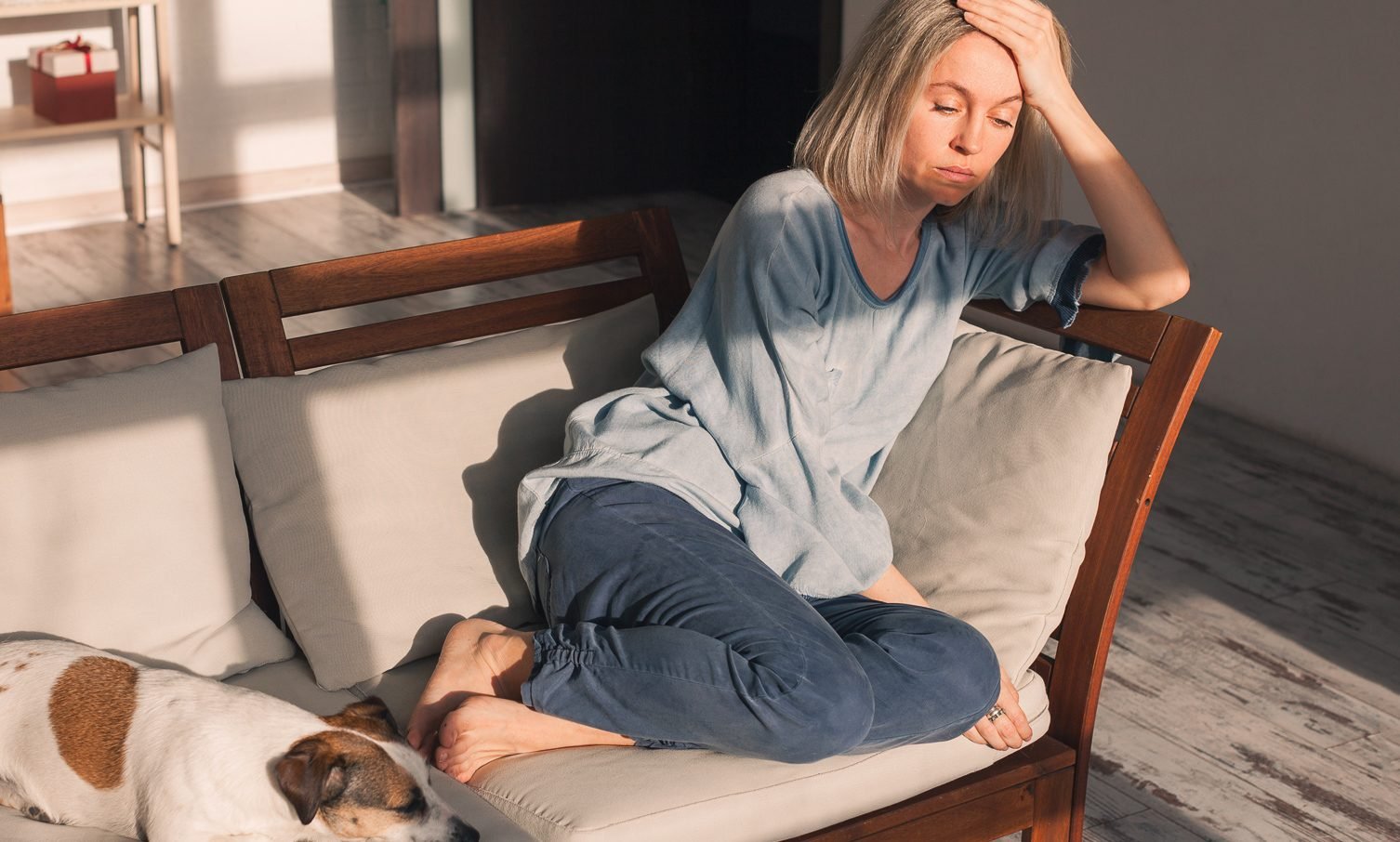 woman_menopause_tired_thinking_with_dog-aspect-ratio-1506-906