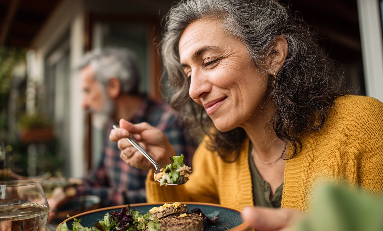 woman eating a dish full of proteins